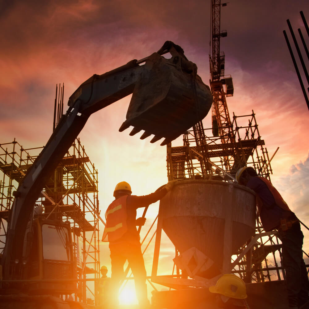 Construction workers amidst machinery in the evening sunshine