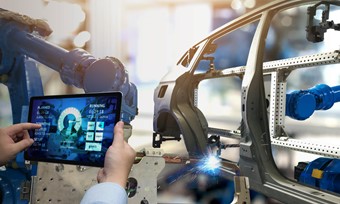 Individual with a tablet interacts with a robot