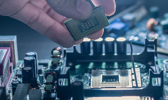 A hand placing a CPU chip into a computers circuit board