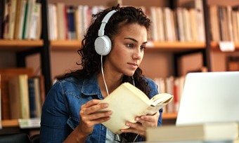 Girl Looking At Laptop And Books