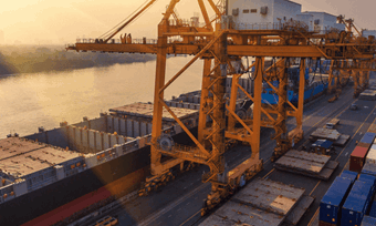 A large container ship anchored in the water