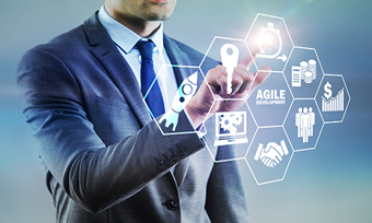 Businessman in suit using virtual interface with icons.