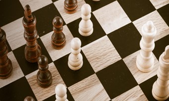 An array of chess pieces positioned on a chessboard